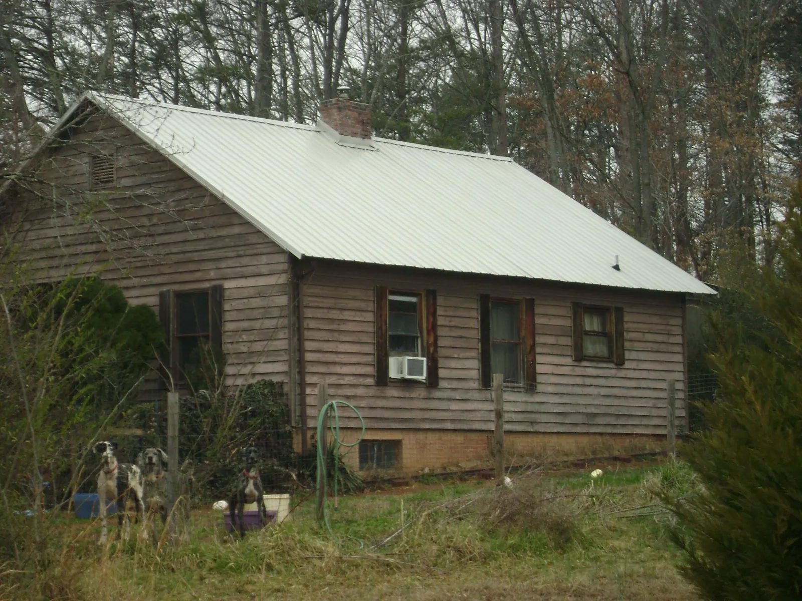 White metal roof on an old wood sided farmhouse, from a Metal Roof Installation job in Kensett