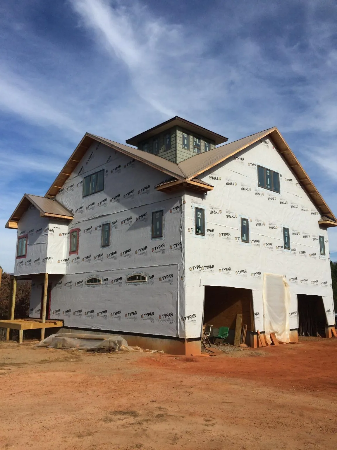 New two story house under construction with a cupola and gabled roofs in Kensett